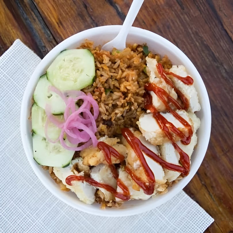 Chubby Bao House fried rice bowl with crispy chicken, sriracha, cucumber, and pickled onions.